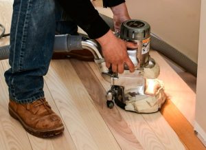 Person sanding wood floor